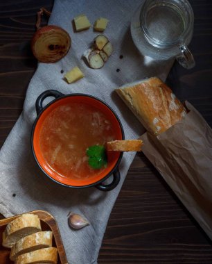 Baget ve fırında sebzeli keten peçetede soğan çorbası ve kızarmış ekmek.