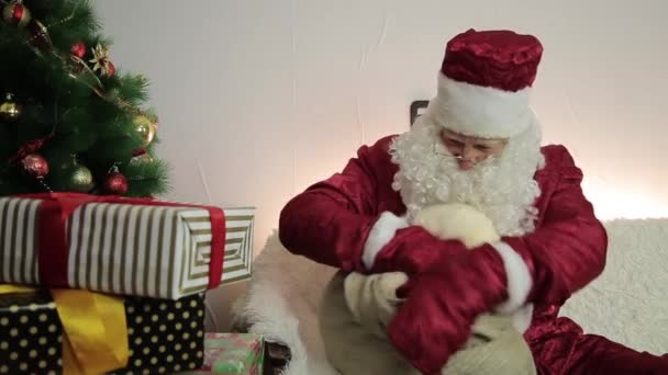 산타 클로스 가방에서 선물을 가져옵니다.. — 비디오