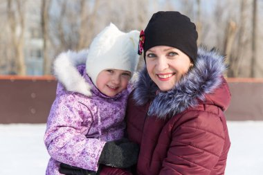 Anne güzel kızı kışın pistinde hugs.