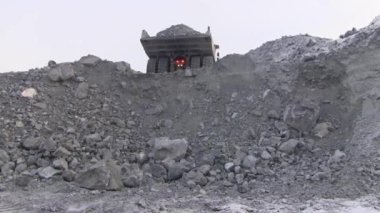 Büyük bir çöp kamyonu cevheri 50 ton uçurumun dökülen. Bir kariyer taşlar arabaya gövdesini pour.