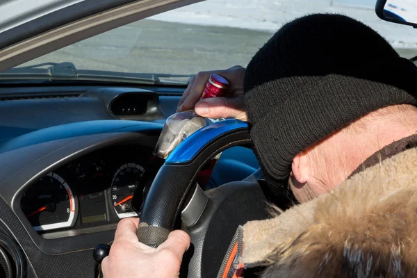 The driver got drunk liquor and fell asleep in the car.