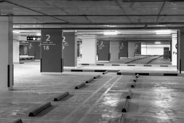 Underground empty car parking. Black and white image Photo of the parking lot of a shopping complex without people.