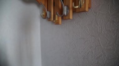 Salgın bir virüsün yüz maskesi giyiminin zorunlu bir özelliğidir. Bir adam asıyor bir ceket ve bir maske asıyor virüsten bir askıya.