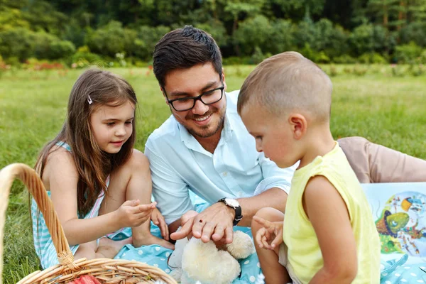 Padre con niños divirtiéndose en el parque. Familia feliz en la naturaleza — Foto de Stock