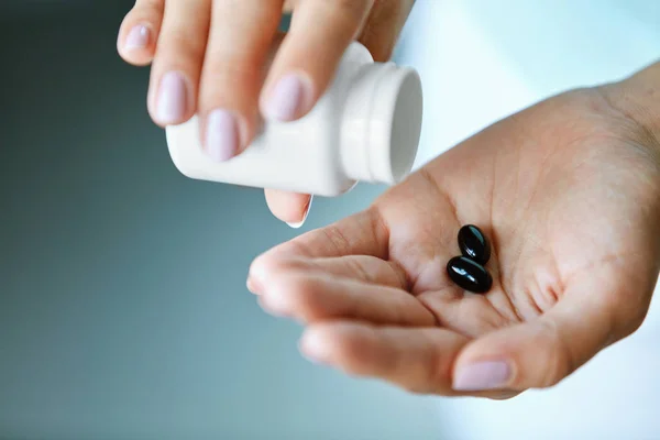 Medizin. Nahaufnahme einer weiblichen Hand, die Pillen in die Handfläche gießt — Stockfoto