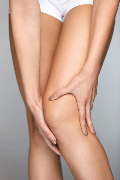 Біль у коліні. Крупний план жіночої ноги з болючим почуттям в коліні — стокове фото