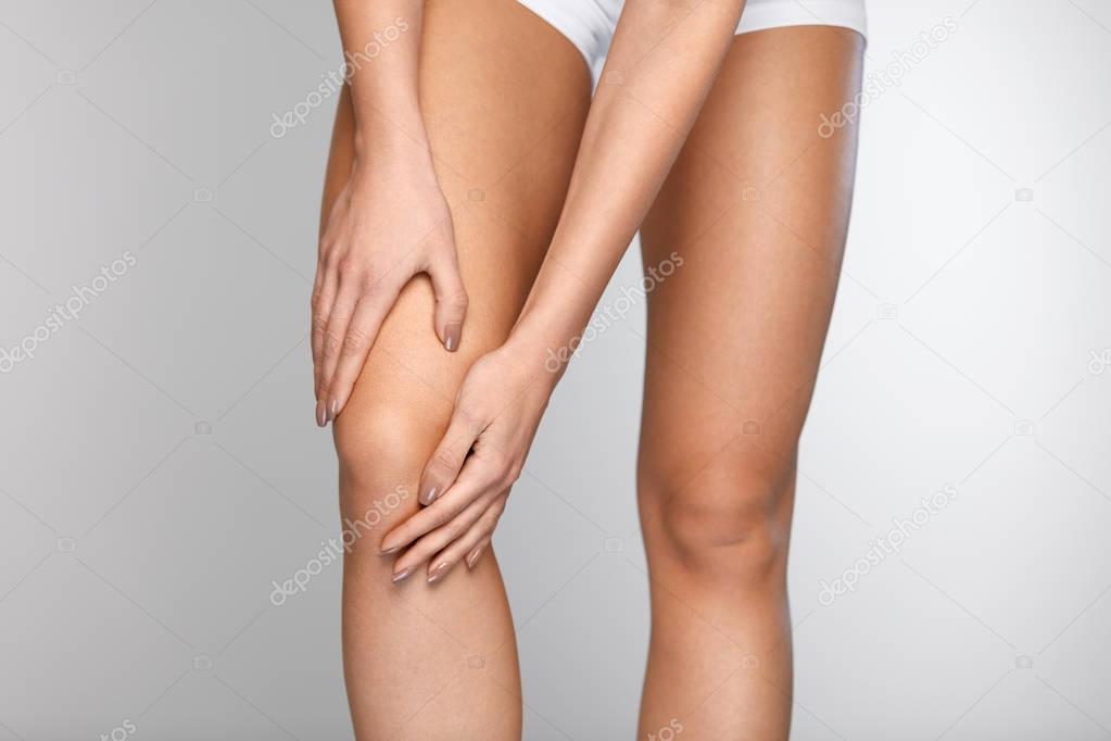 Body Pain. Close-up Of Beautiful Female Body With Pain In Knees