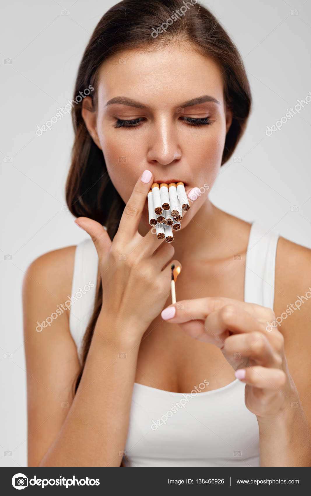 Smoking Cigarette. Woman Lighting Cigarettes With Match Stock Photo by