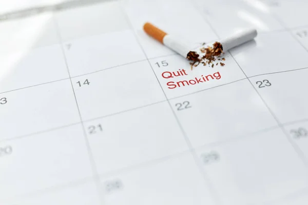 Quit Smoking. Close Up Of Broken Cigarette Lying On Calendar