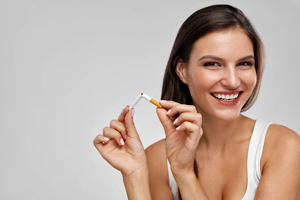 Leszokni a dohányzásról. Szép boldog nő törött cigaretta tartó — Stock Fotó