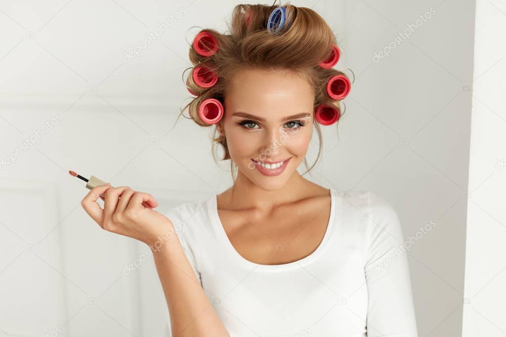 Beauty. Girl With Hair Curlers Curling Hair, Putting Lip Gloss