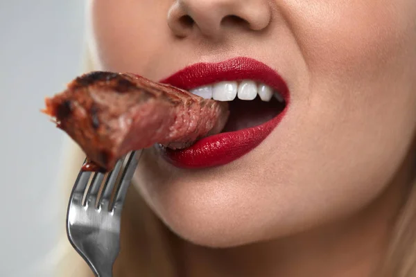 Woman Mouth Biting Meat. Beautiful Female Mouth Eating Meat