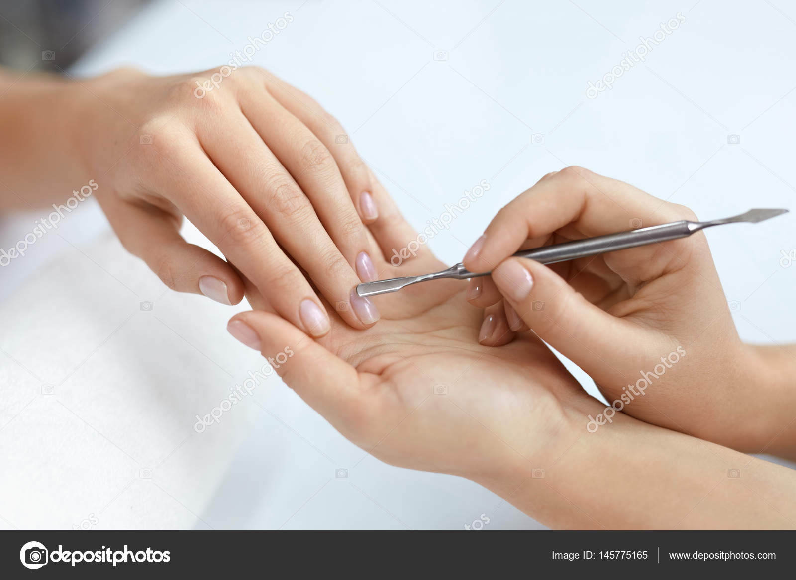 Premium Photo | Nail care procedure on pink background, close up