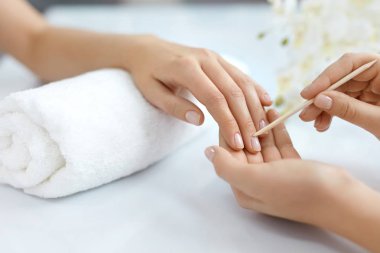 Salon çivi. Ahşap sopa ile eller closeup. Manikür