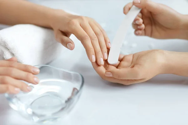 Primer plano hermosas manos femeninas tener manicura de spa, limar uñas — Foto de Stock