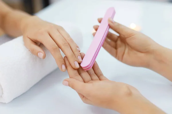 Manicure. Female Hands Polishing Nails With Nail File In Salon