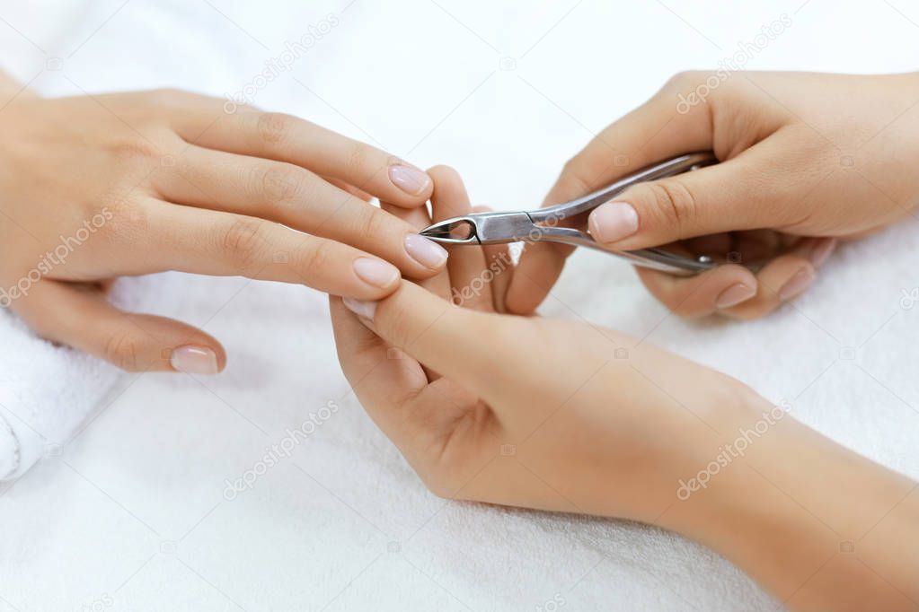 Nails Beauty. Woman Hands Cutting Cuticle With Nail Clippers