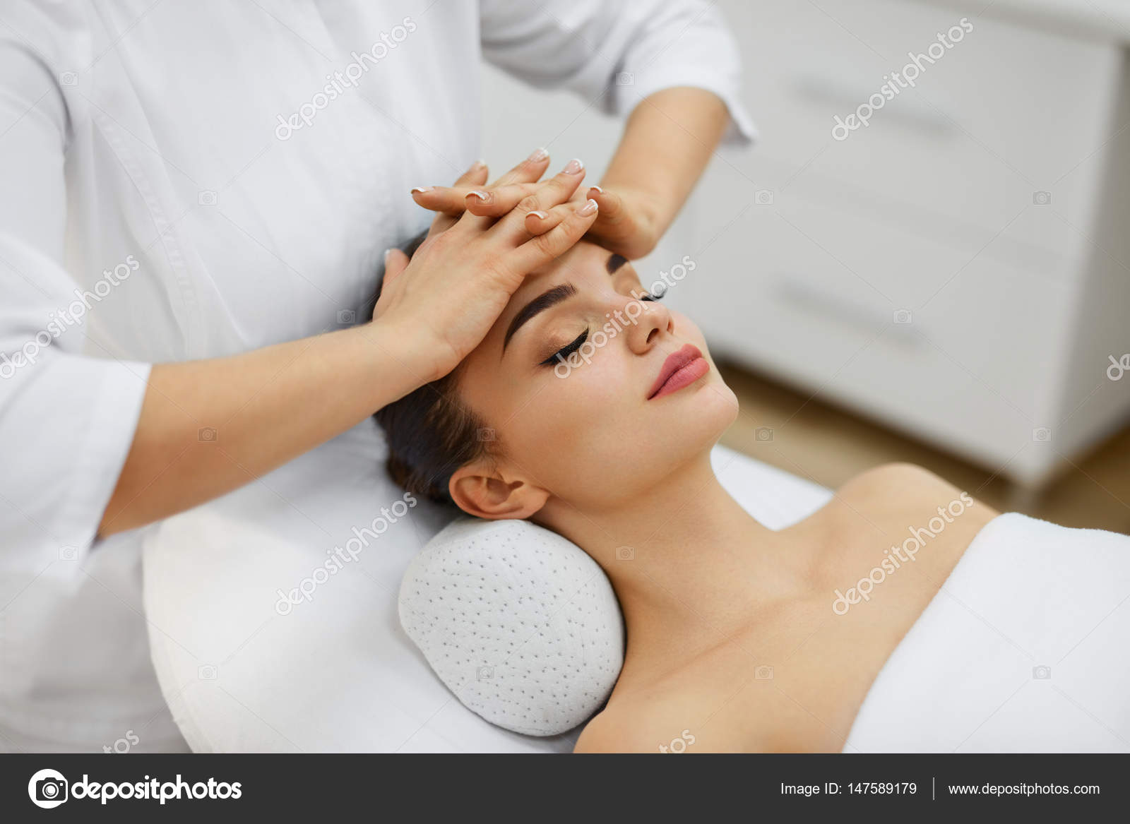 Woman Skin Care. Beautiful Female Model Receiving Face Massage Stock