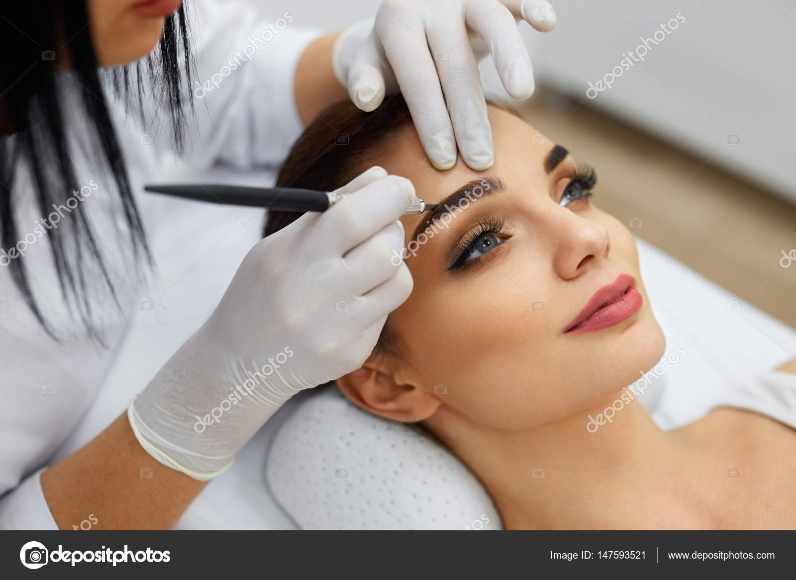 Beautician Doing Permanent Eyebrows Makeup Tattoo On Woman Face Stock Photo  by ©puhhha 147593521