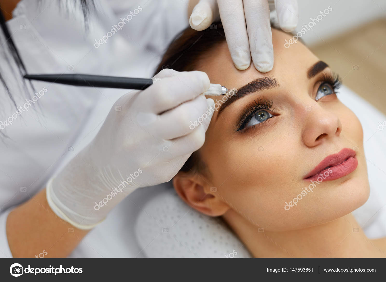 Beautician Doing Eyebrow Makeup Tattoo On Woman Using Machine Stock Photo  by ©puhhha 147593651