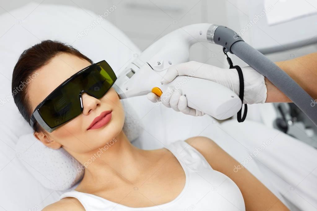 Laser Hair Removal. Woman At Spa Clinic Receiving Face Treatment