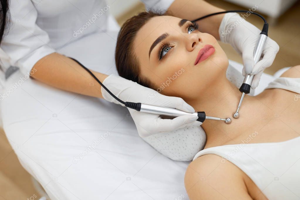 Cosmetology. Woman At Spa Receiving Microcurrent Therapy