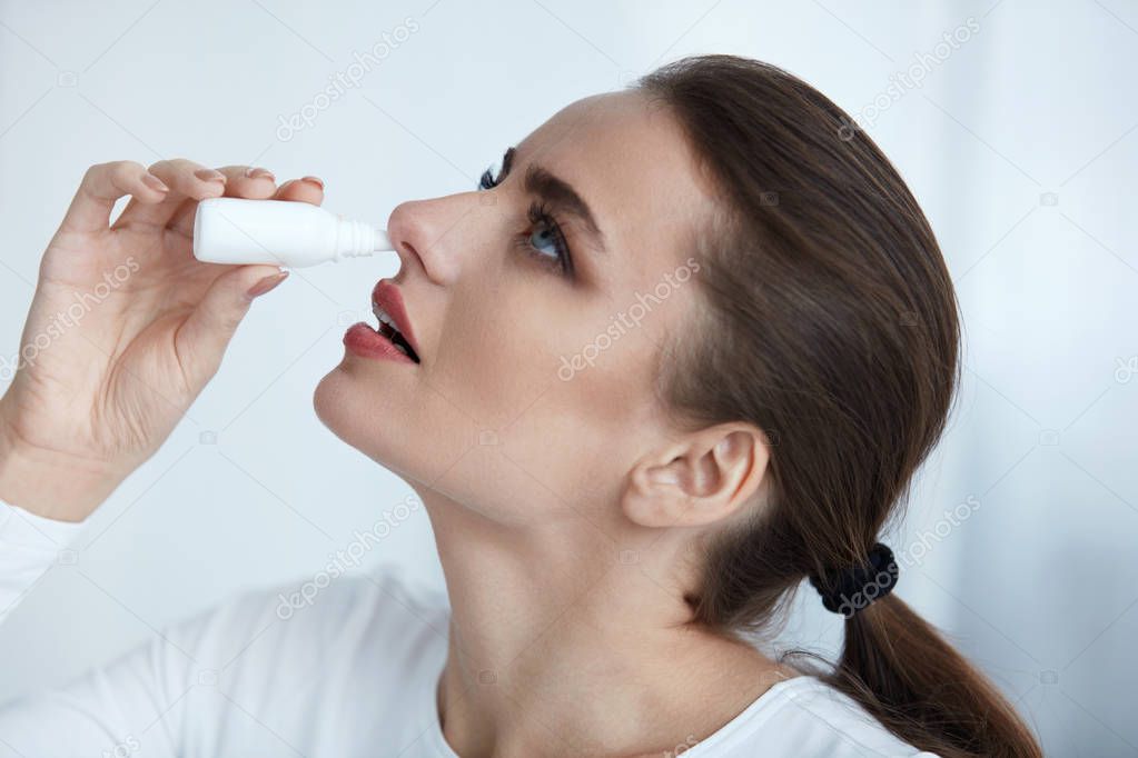 Beautiful Woman With Flu Or Cold Using Nasal Spray