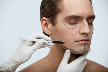 Plastik cerrahi. Portre yakışıklı yüz siyah çizgiler ile