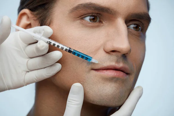 Closeup Of Handsome Man Face Getting Beauty Injection