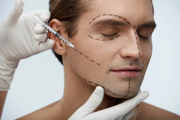 Hombre guapo con líneas faciales recibiendo inyecciones de belleza facial — Foto de Stock