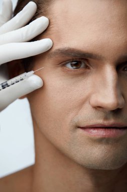 Handsome Man Getting Facial Beauty Treatment, Filler Injections clipart