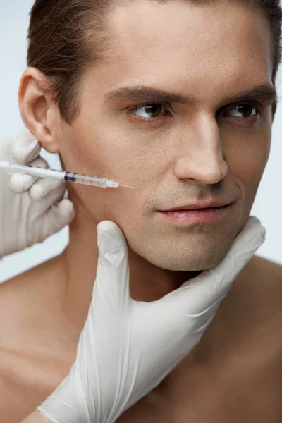 Pohledný muž dostává obličejové kosmetické ošetření, výplň injekce — Stock fotografie