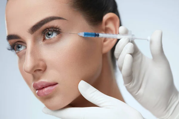 Woman Face Receiving Beauty Injections In Skin