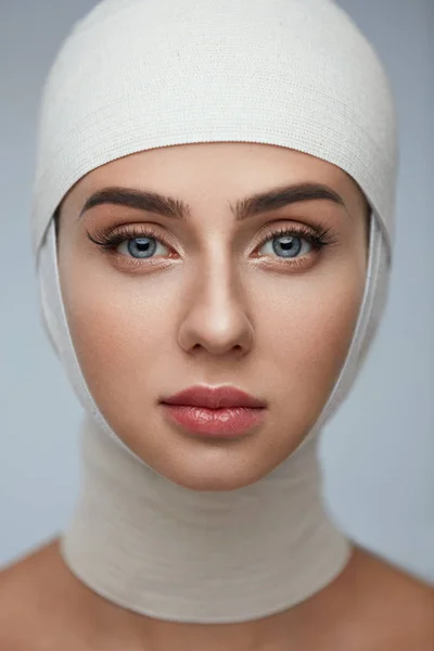 Woman Face With Smooth Soft Skin And Perfect Makeup In Bandages — Stock Photo, Image