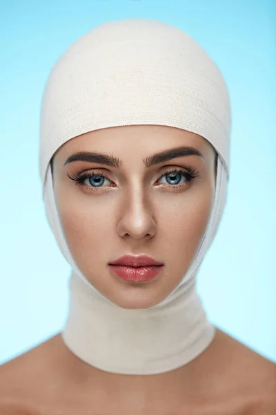 Woman Face With Smooth Soft Skin And Perfect Makeup In Bandages