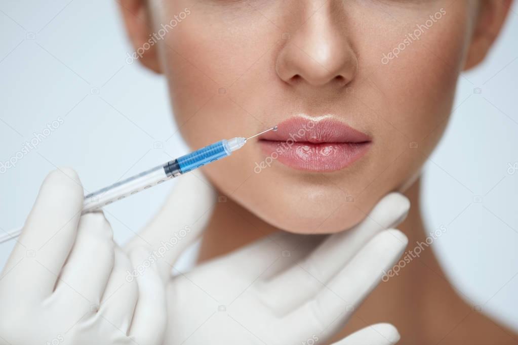 Lip Augmentation. Young Woman Lips Receiving Beauty Injection