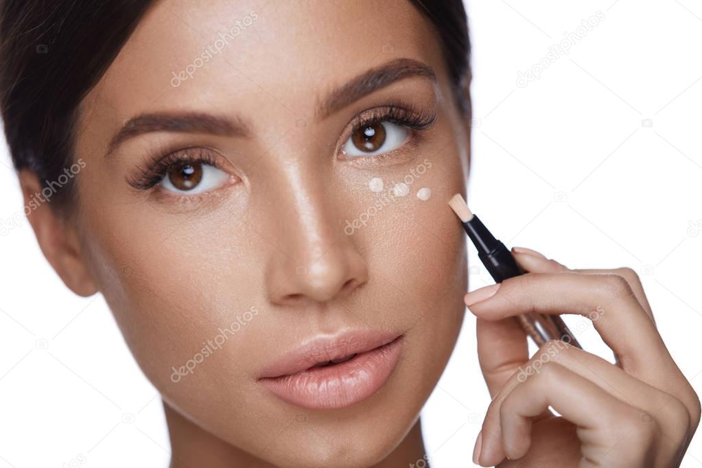 Beauty Woman Face Makeup. Female Applying Corrector Under Eyes