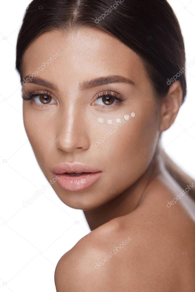 Skin Care. Portrait Of Sexy Girl Using Concealer Under Eyes