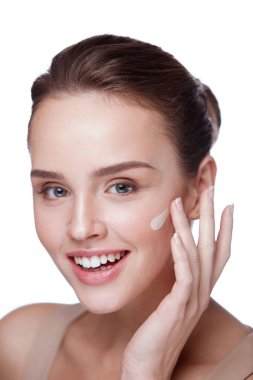 Cosmetics. Beautiful Girl Applying Cream On Face. Beauty Makeup  clipart