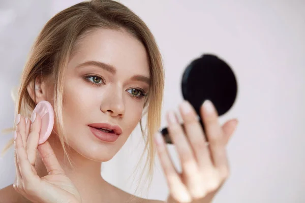 Face Make-Up. Female With Mirror Putting Cosmetic Powder