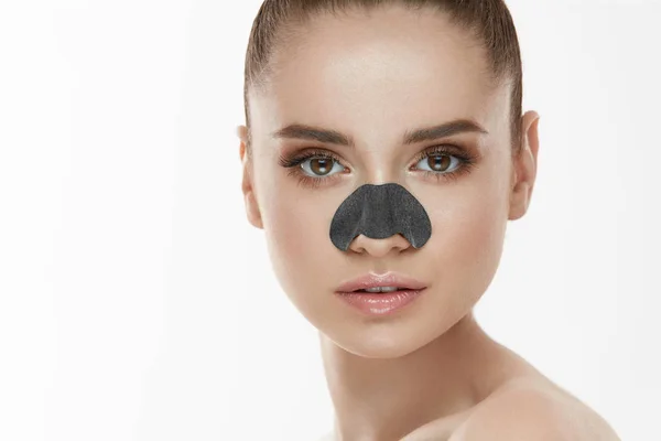 Cosmetologie. Mooie vrouw met zwart masker op neus — Stockfoto