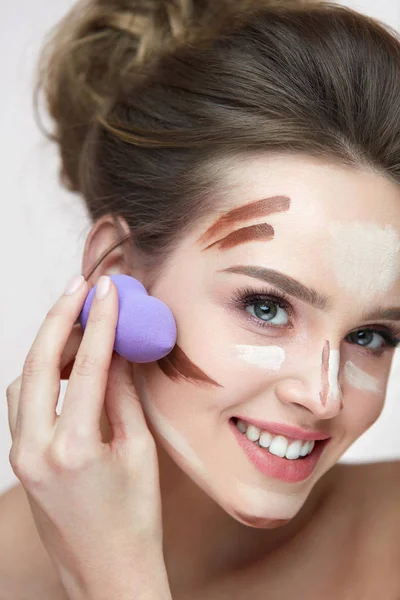 Ansikte Makeup skönhet. Vacker kvinna tillämpa Makeup med svamp — Stockfoto