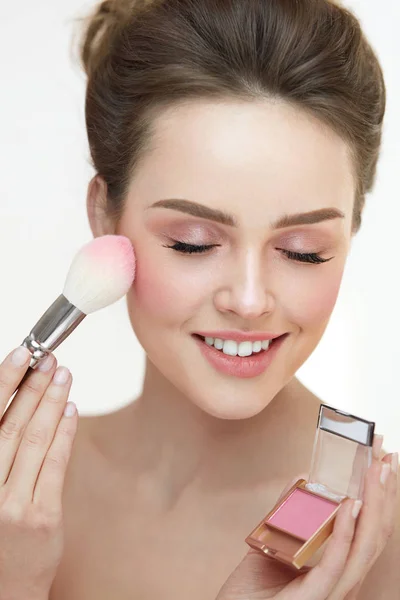 Cosmétiques de beauté. Mains Application Blush sur la peau du visage de la femme — Photo