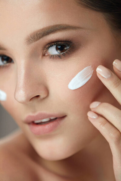 Beauty Cosmetics. Sexy Girl Face With Cosmetic Cream On Skin