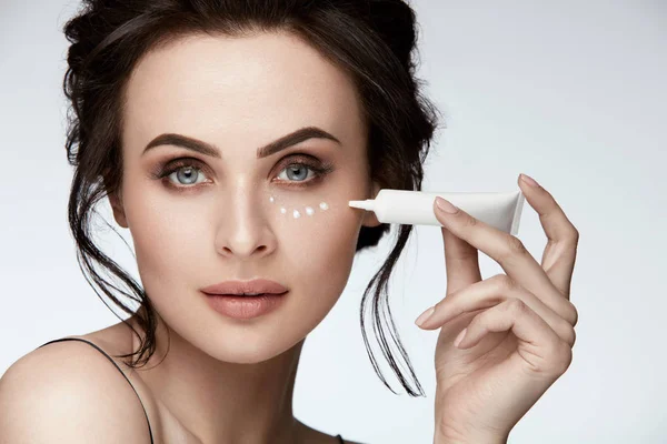 Eye Skin Care. Woman Applying Eye Cream On Skin