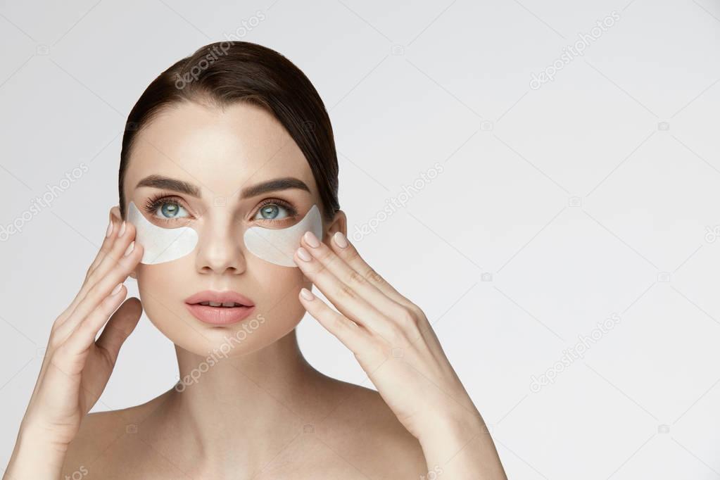 Beauty Face Skin Care. Woman Applying Under-eye Patches On Face
