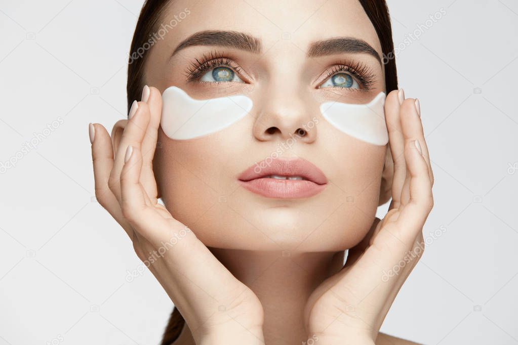 Eye Skin Treatment. Woman With White Under Eye Patches On Face