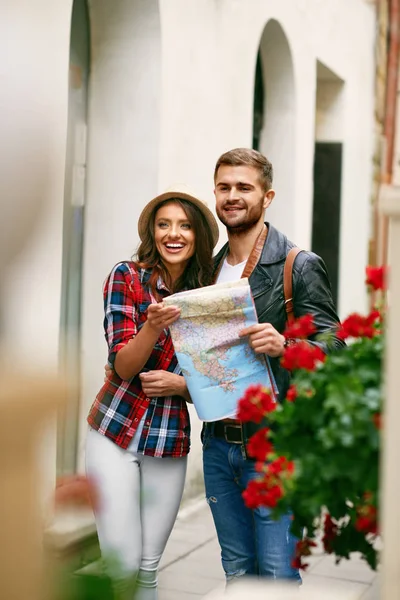 Couple Using Map Traveling On Vacations