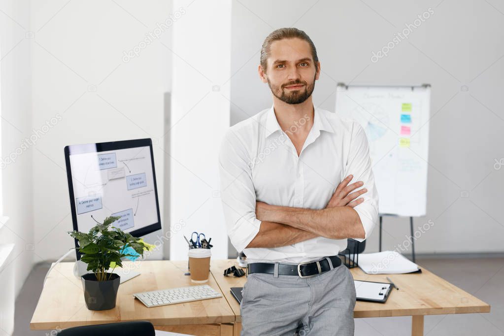 Confident Male Worker Standing In Office