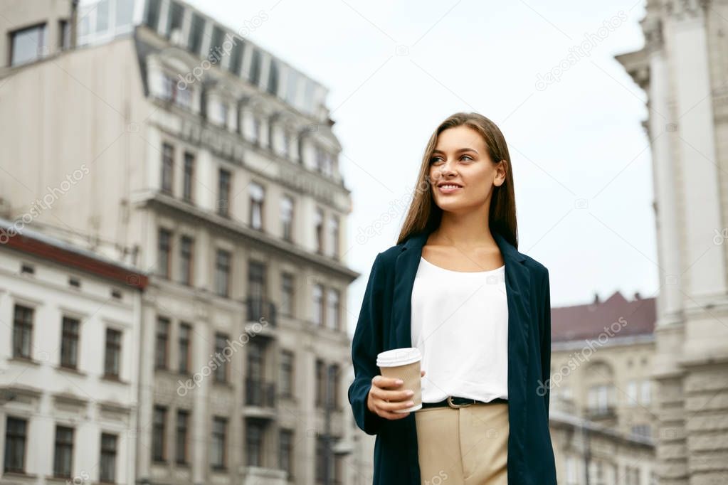 Beautiful Business Woman With Drink On Go Walking On Street.